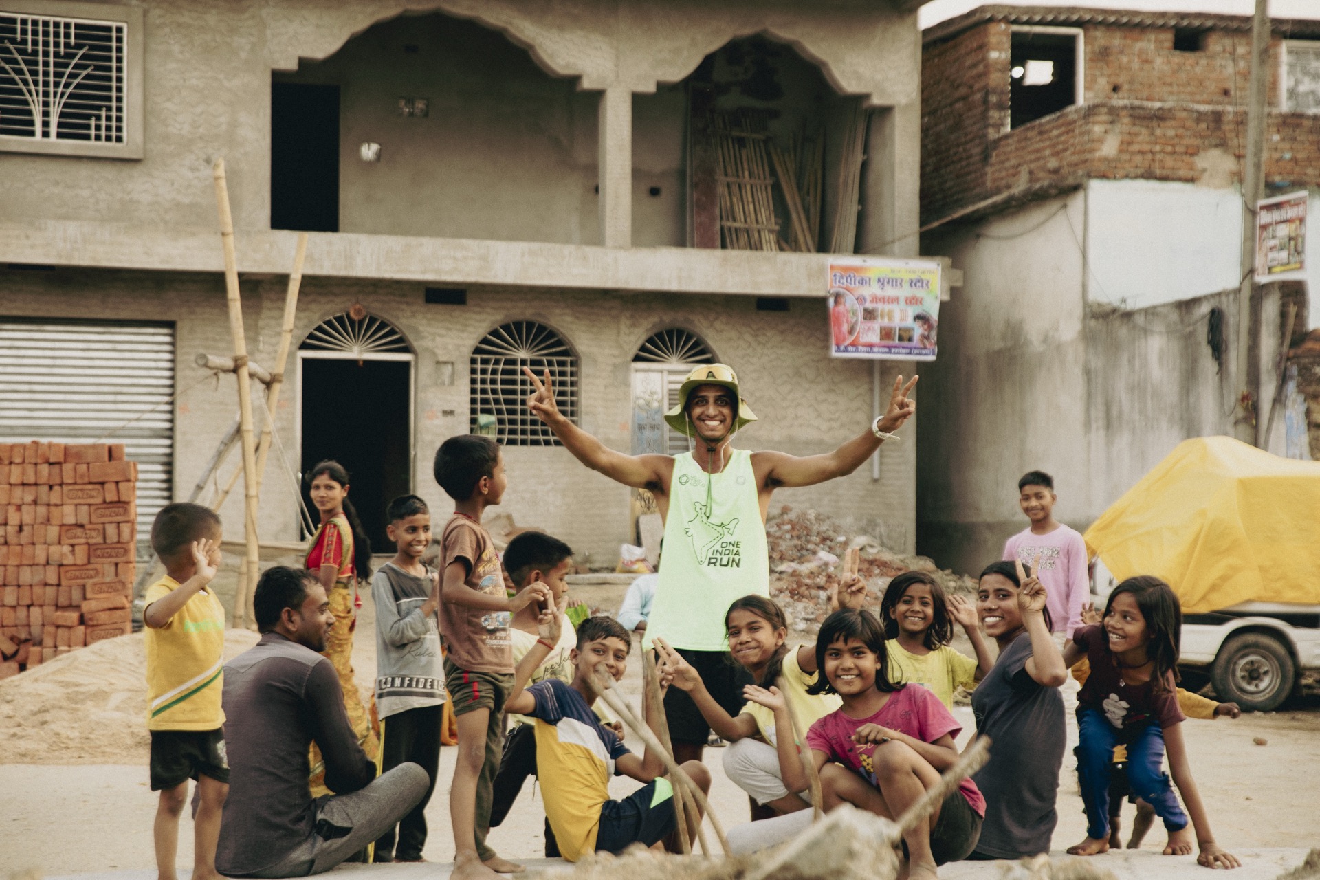 Running with a crowd of cheering kids at a village stop
