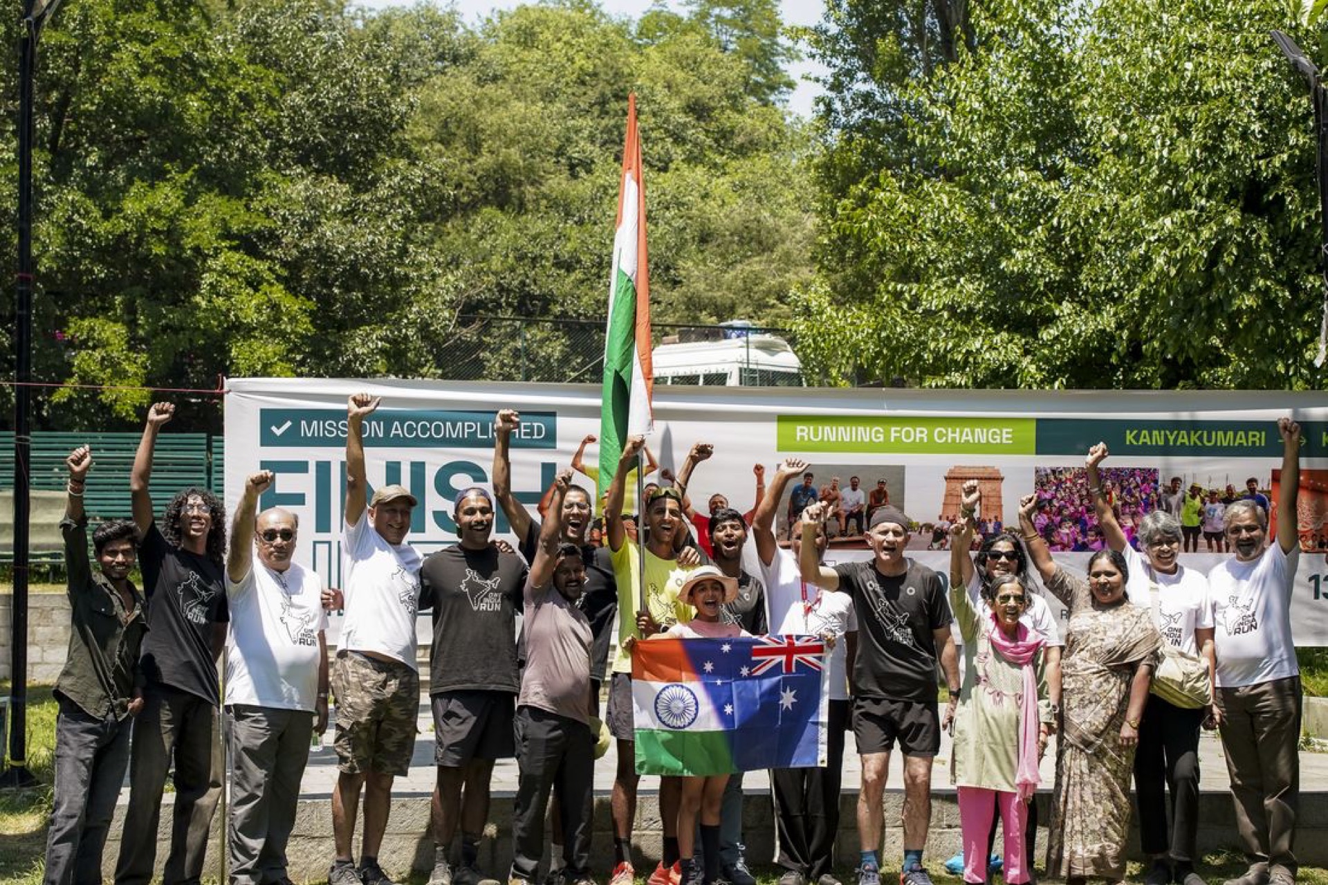Mission accomplished: the crew celebrating with flags at the finish, Dal Lake