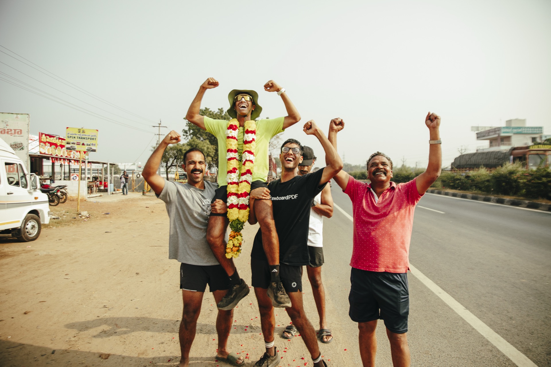 Garlanded and celebrating with the crew on the road